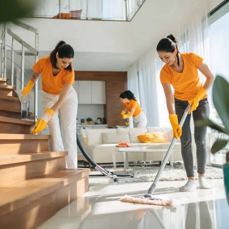 Three women tidying up a modern living room — the Lytham Cleaning team at work