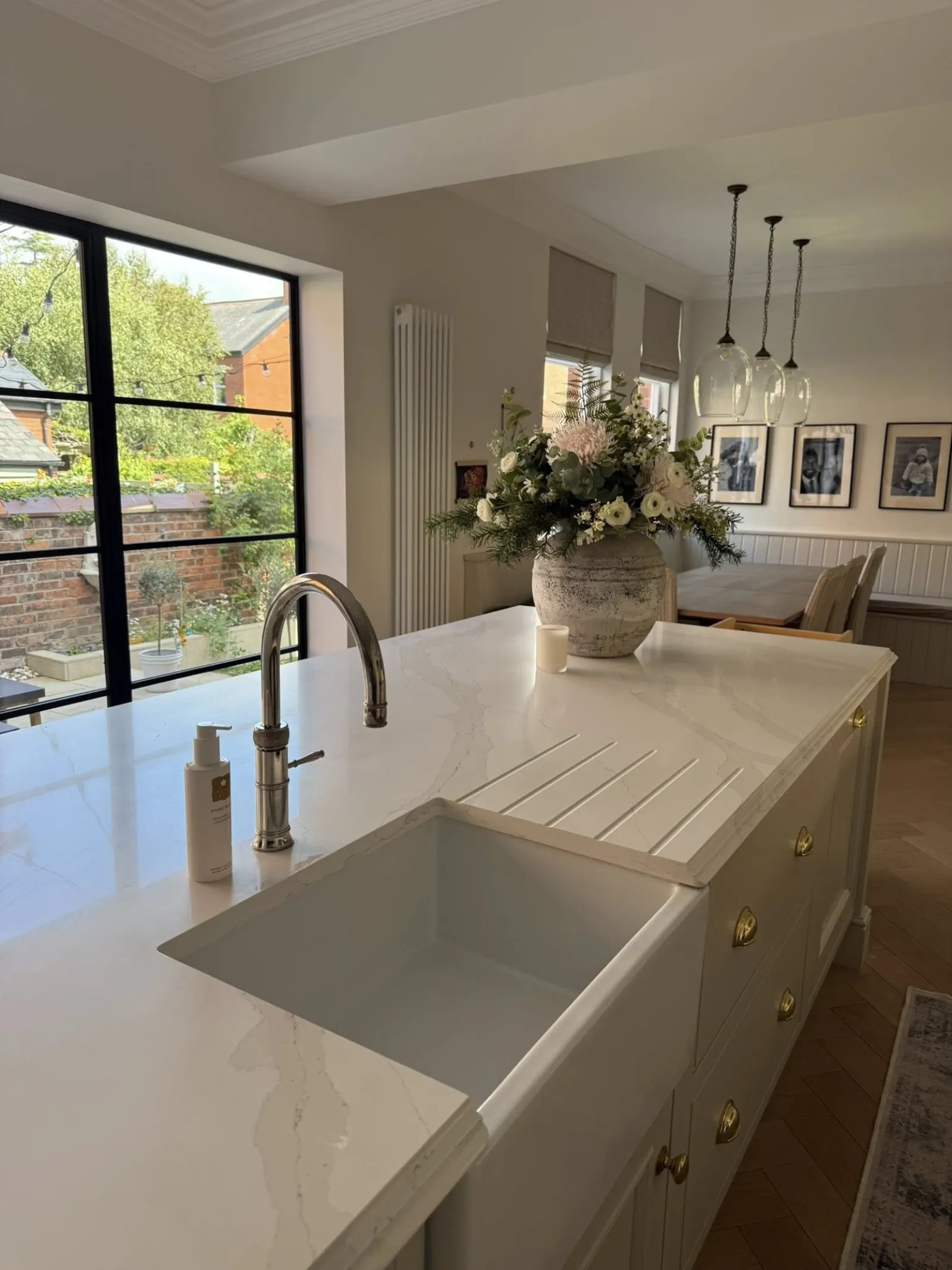 Spotless white kitchen with marble countertops cleaned by The Lytham Cleaning Company