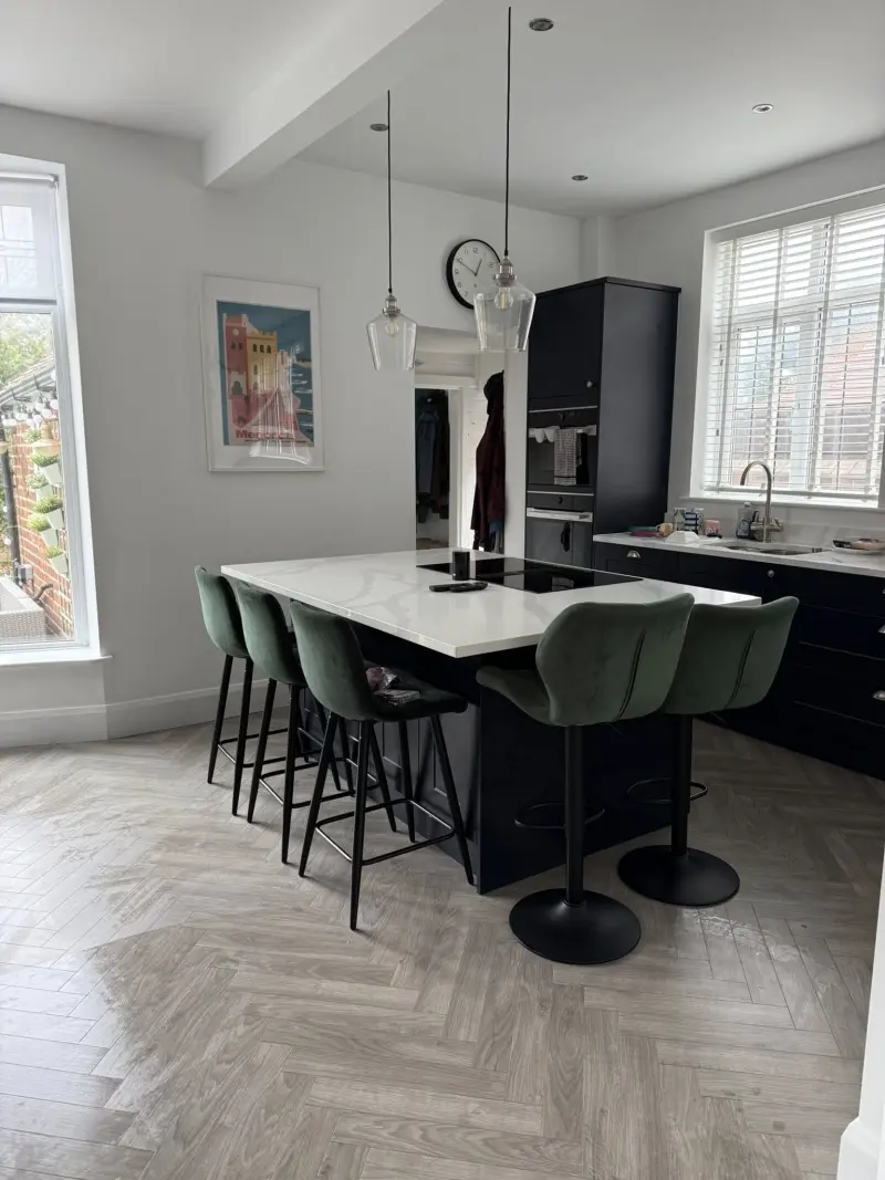 Modern kitchen with island and herringbone floor after cleaning